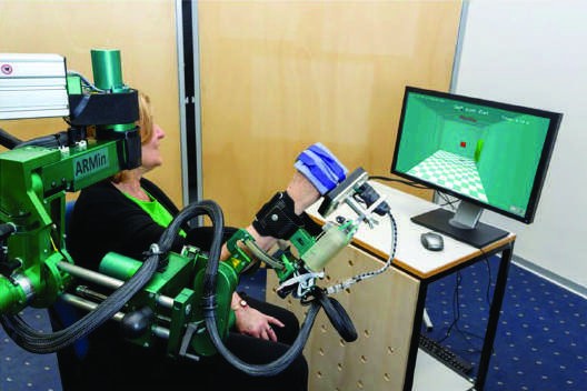 Photograph of a subject interacting with a complex upper-limb to...